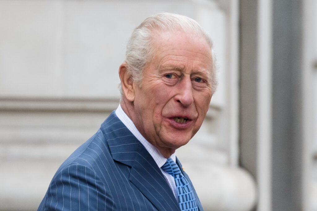 King Charles in blue suit talking