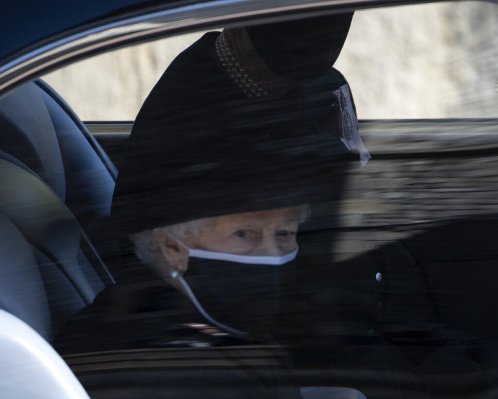 The Queen arrives to Prince Philip, The Duke of Edinburgh's Funeral, photographed in a car wearing a black mask