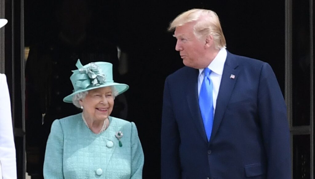 Queen Elizabeth II smiling as Donald Trump speaks