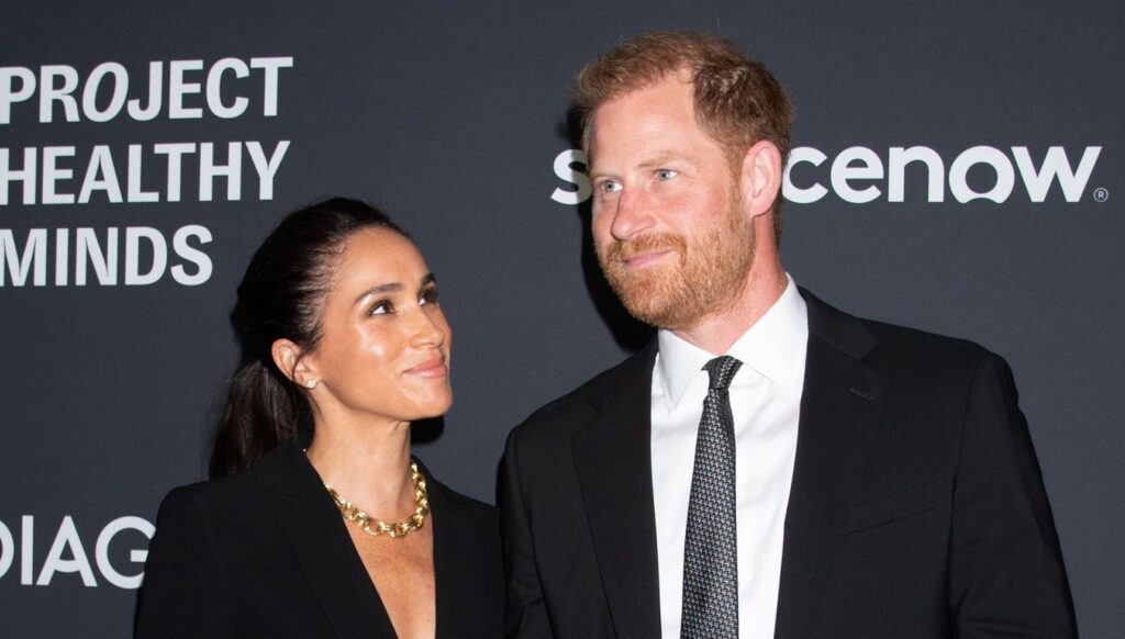 Meghan Markle looking up at Prince Harry at event