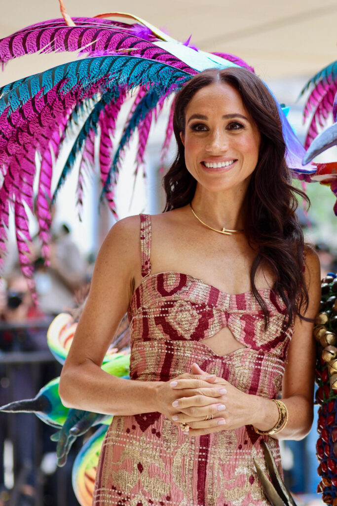 Meghan Markle smiiling in strapless printed dress