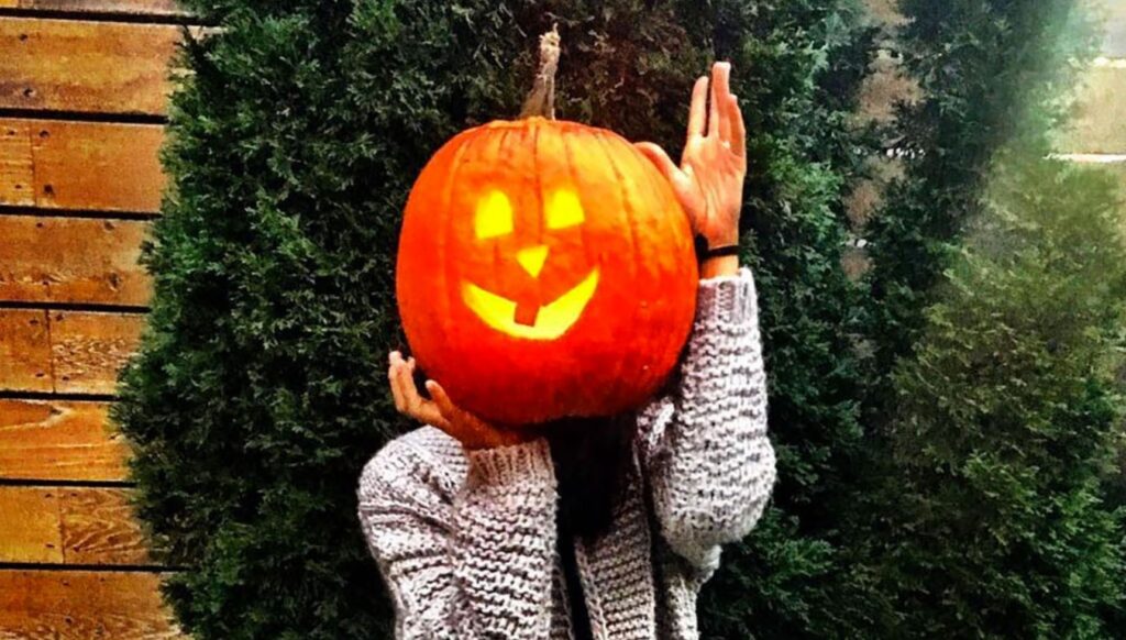 Meghan Markle wearing a light up pumpkin head