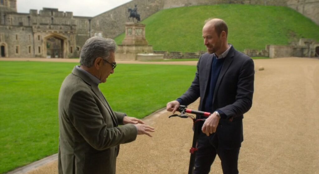 Prince William talking to Eugene Levy on electric scooter in interview