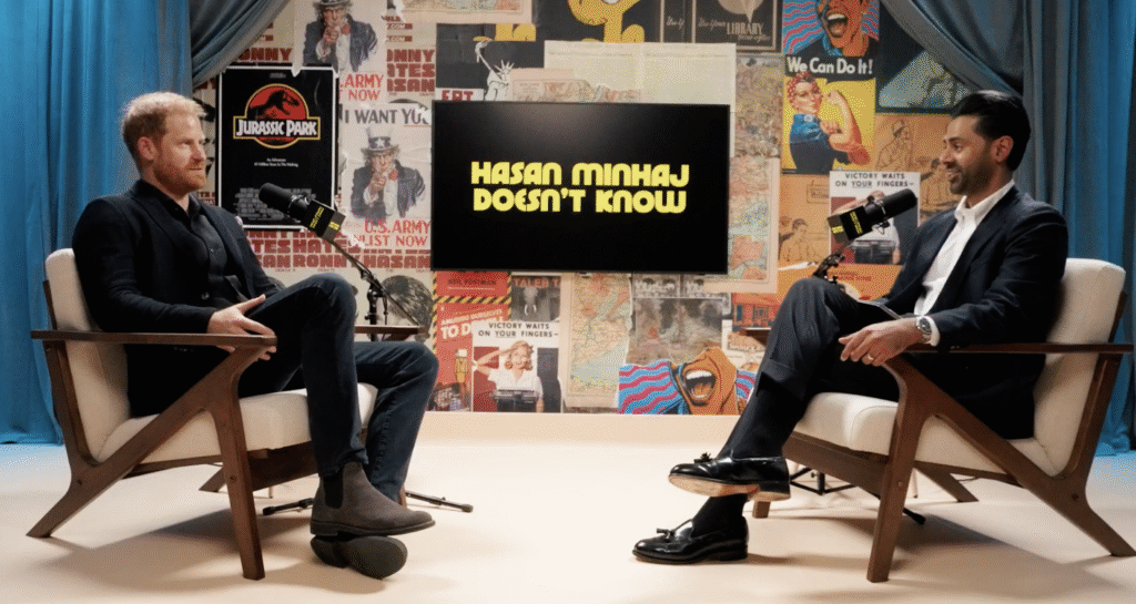Prince Harry in a black suit on Hasan Minhaj's podcast