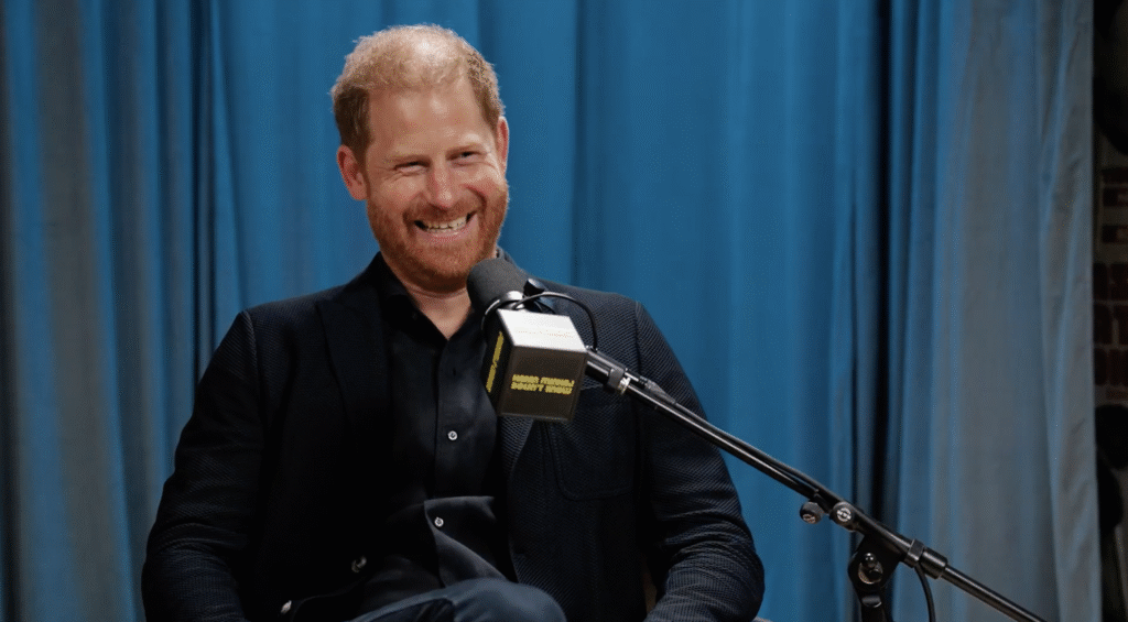 Prince Harry in a black suit on Hasan Minhaj's podcast