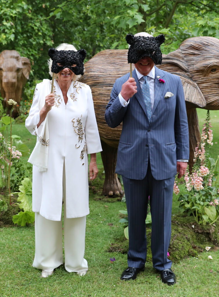 Queen Camilla and King Charles wearing black sequinned masks