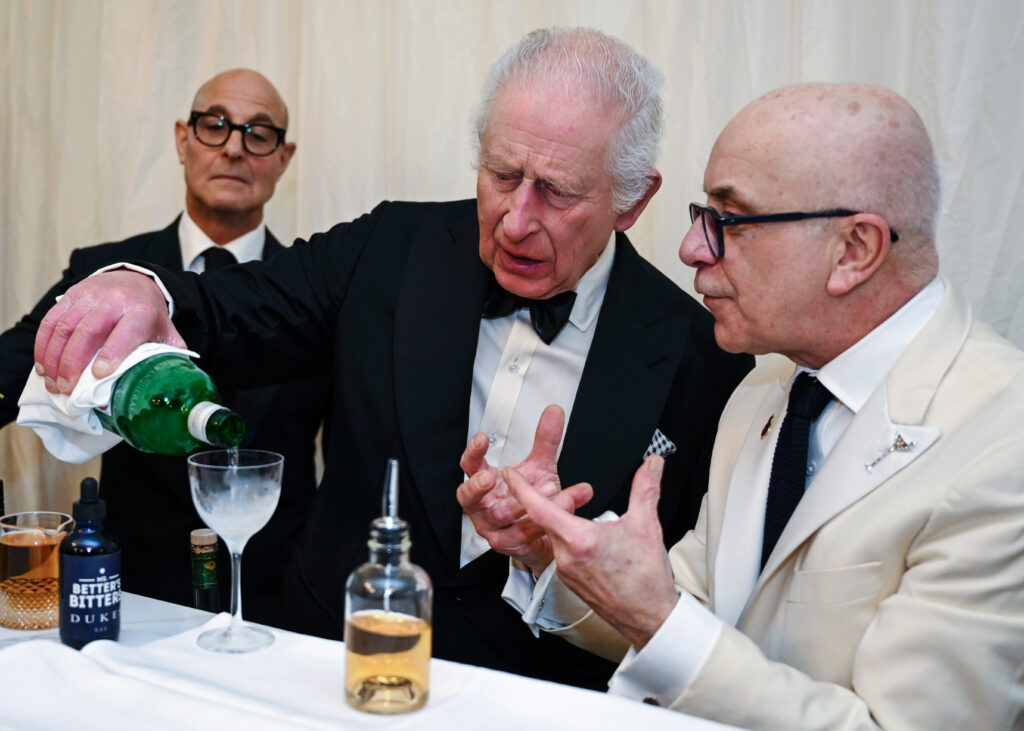 King Charles III and Queen Camilla host Inigo Lambertini, Charles making a beverage beside Stanley Tucci and Alessandro Palazzi