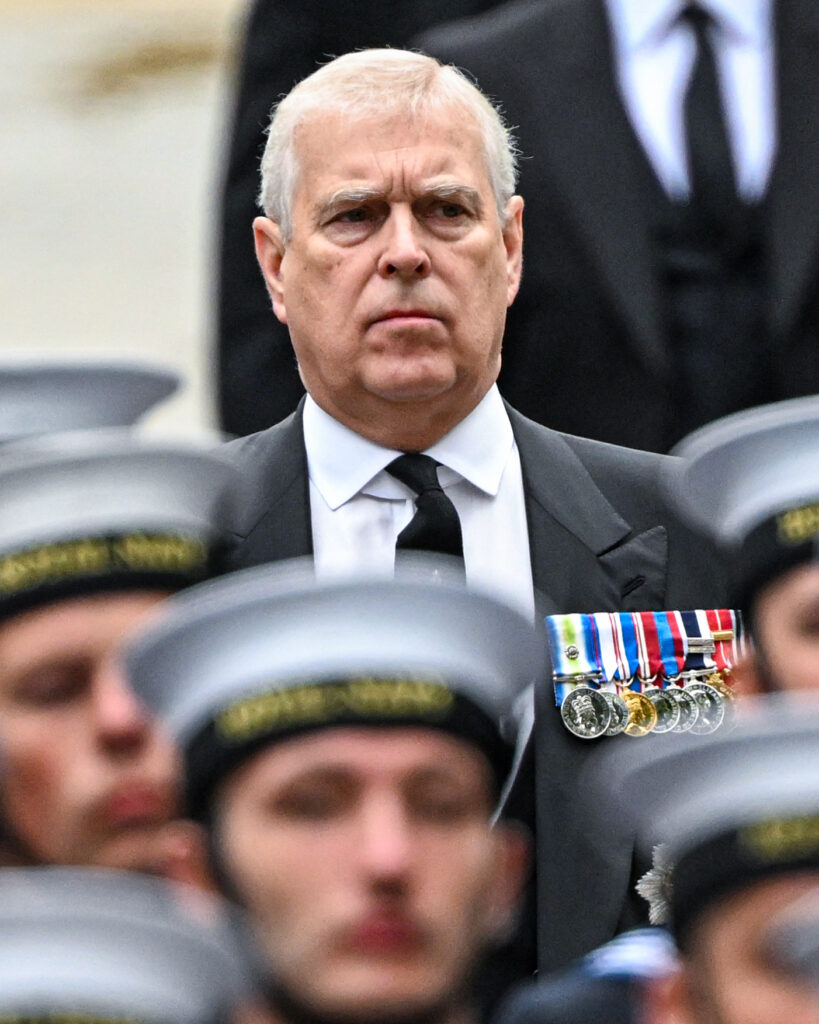 Andrew Mountbatten Windsor frowning whilst walking at the State Funeral of Queen Elizabeth