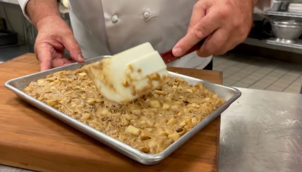 Cake mixture being spooned onto a tray