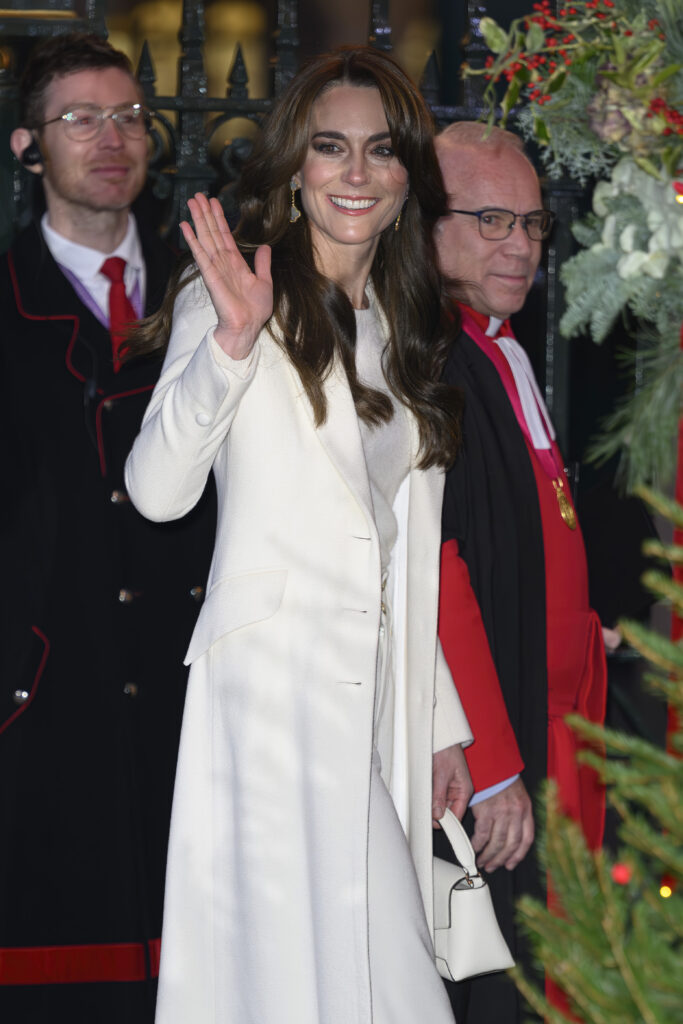 Kate Middleton in white waving while at her Christmas concert