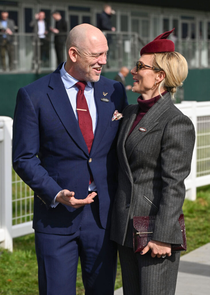 Mike and Zara Tindall smiling at each other at Cheltenham Festival