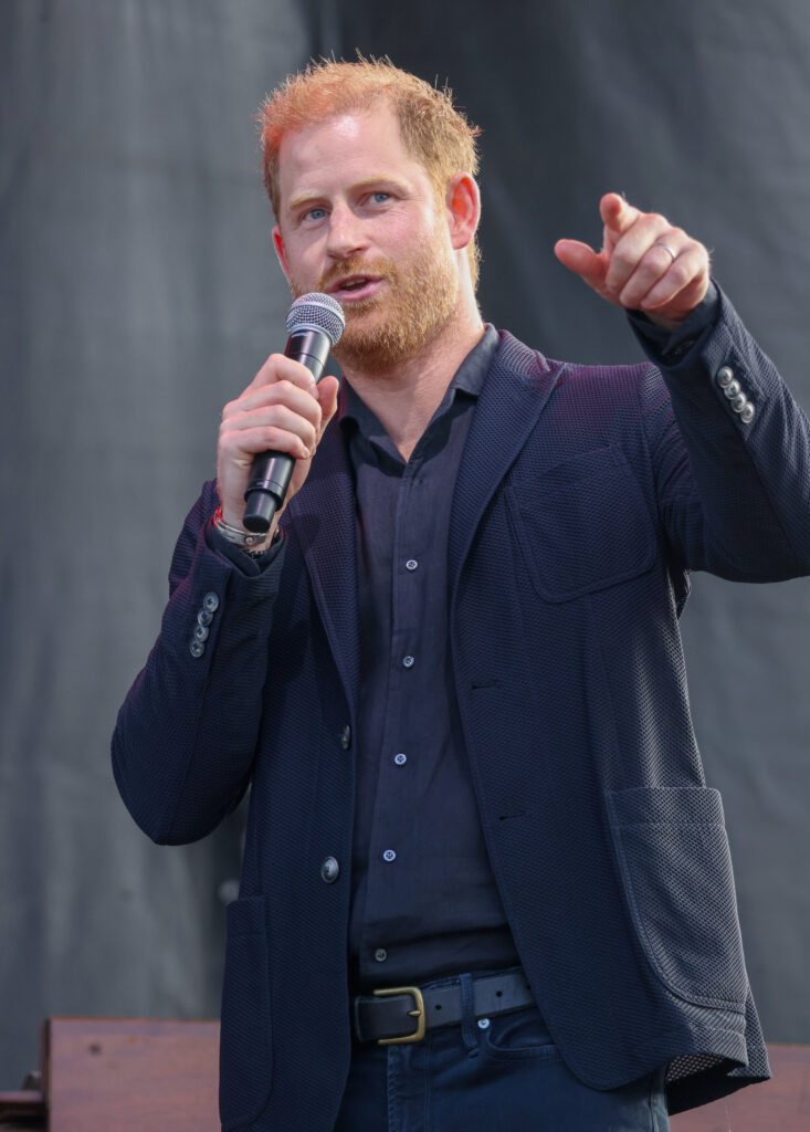 Prince Harry holding a microphone