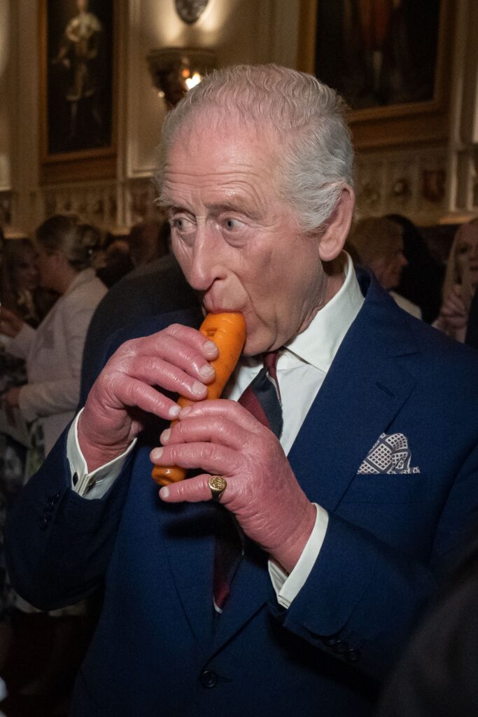 King Charles playing a carrot recorder