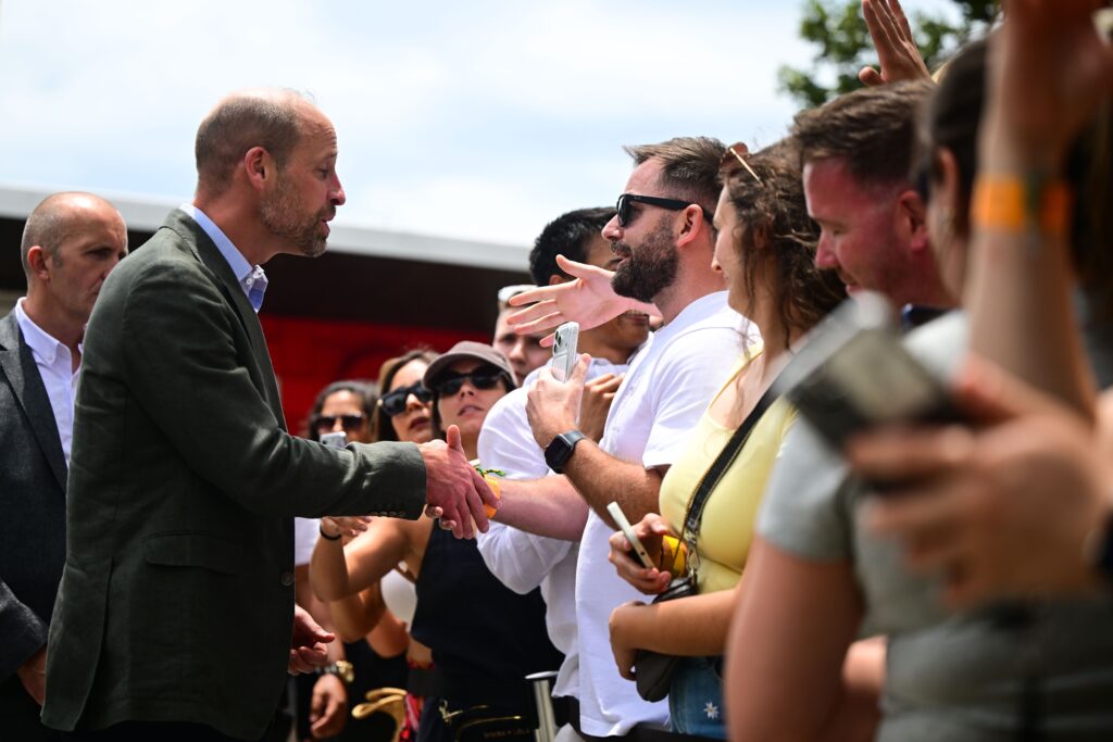 Prince William shaking hands with locals in Brazil