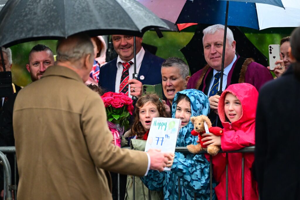 King Charles III greets children in the crowd during visit to Cyfarthfa Castle Museum and Art Gallery, Merthyr Tydfil, Wales