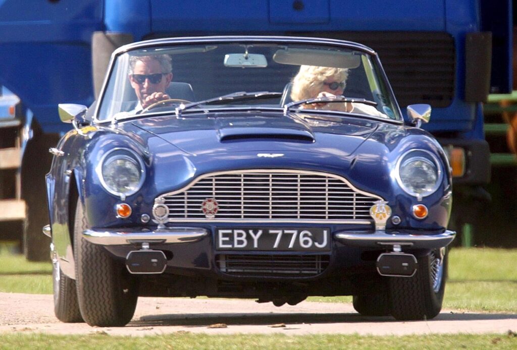 Charles and Camilla in 2003, cruising in an Aston Martin