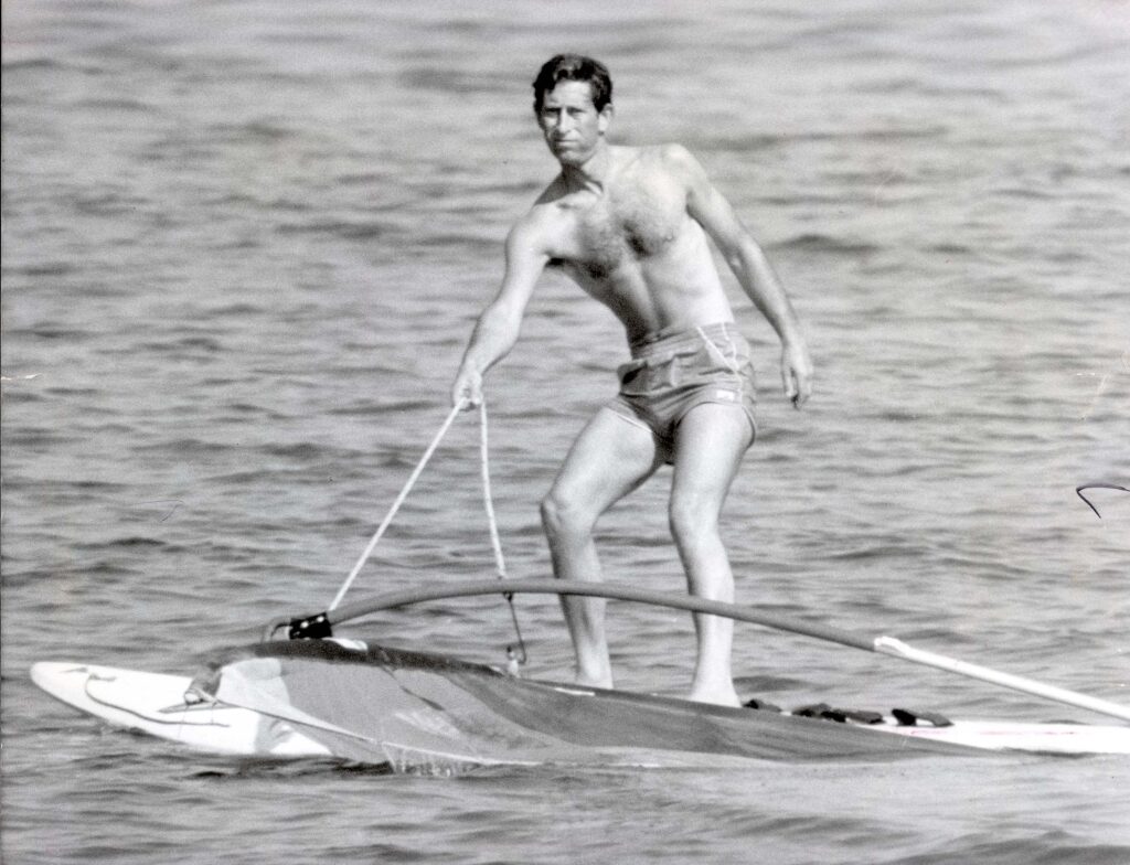 Prince Charles wearing swimming trunks whilst wind surfing in Majorca