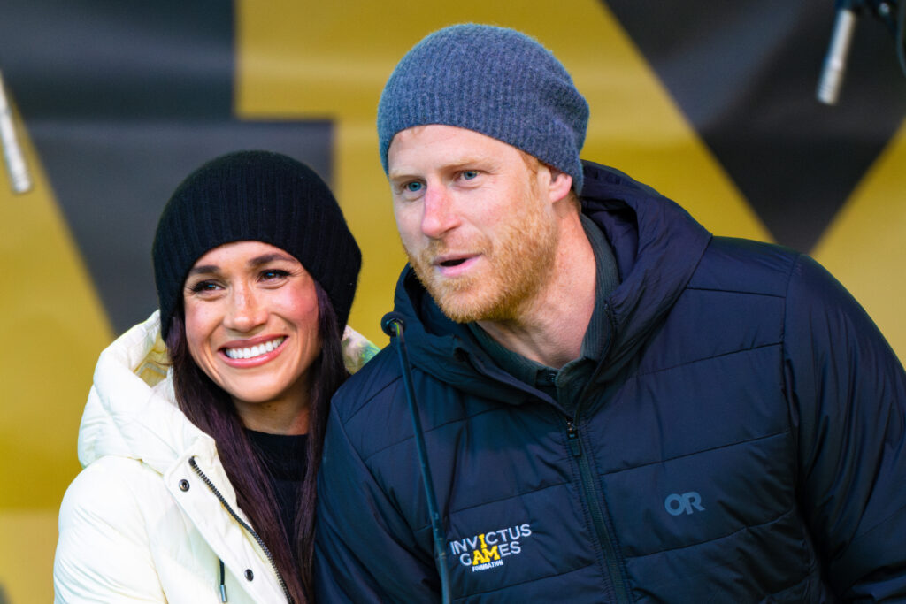Meghan Markle and Prince Harry smiling at Invictus Games