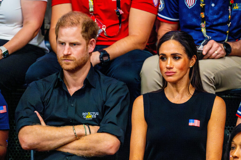 Prince Harry and Meghan Markle sitting at the Invictus Games