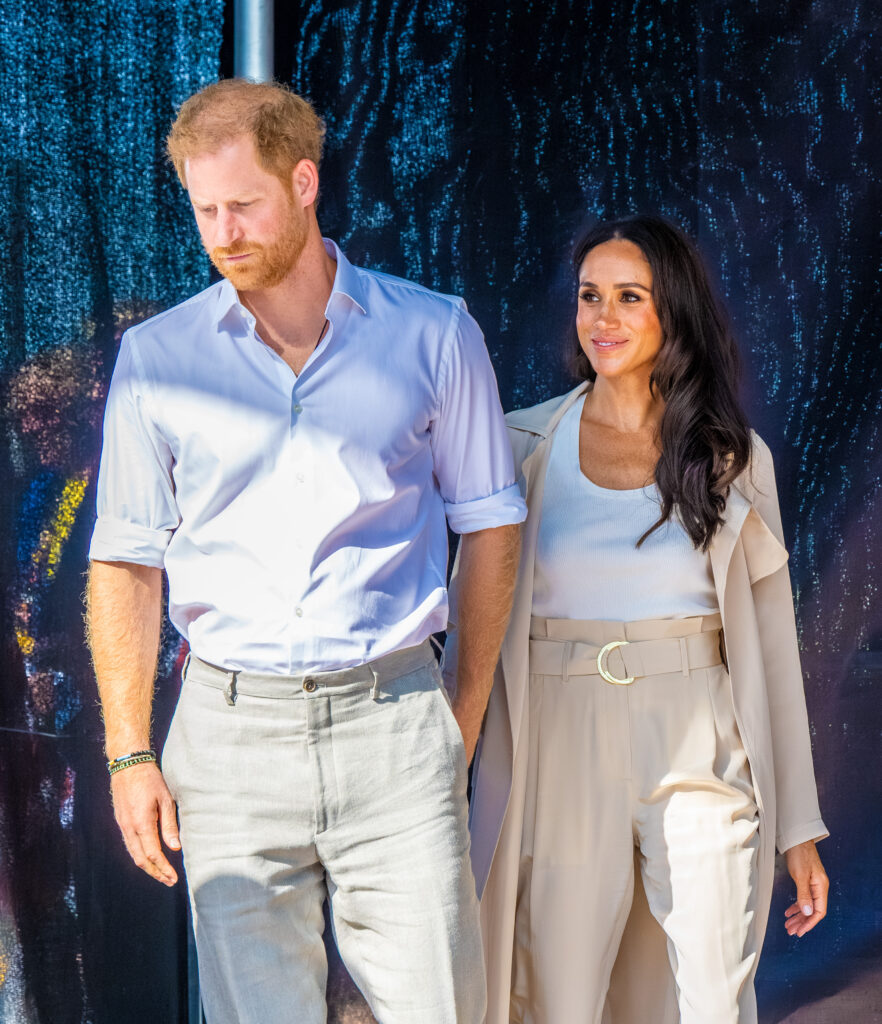 Prince Harry and Meghan Markle holding hands