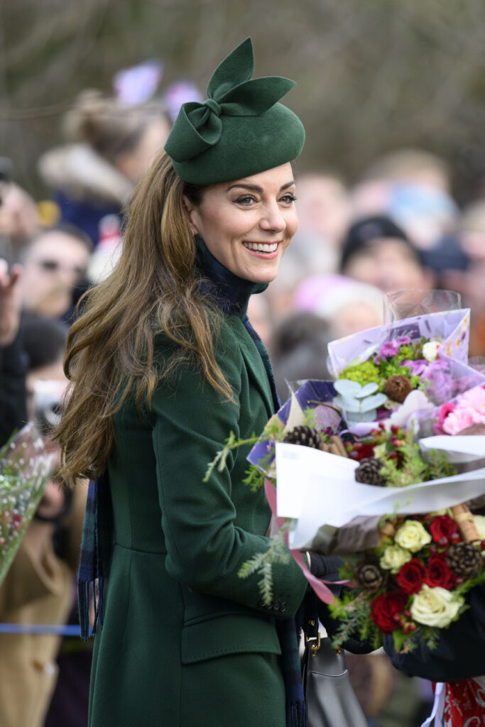 Princess Kate smiling holding flowers
