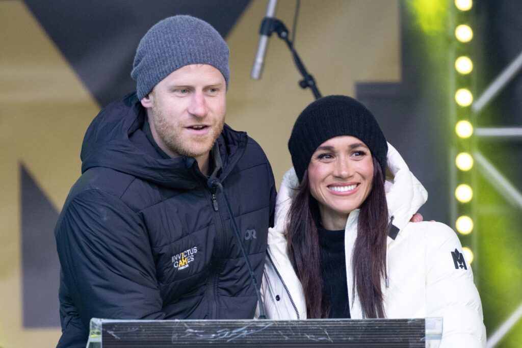 Prince Harry and Meghan Markle giving a speech