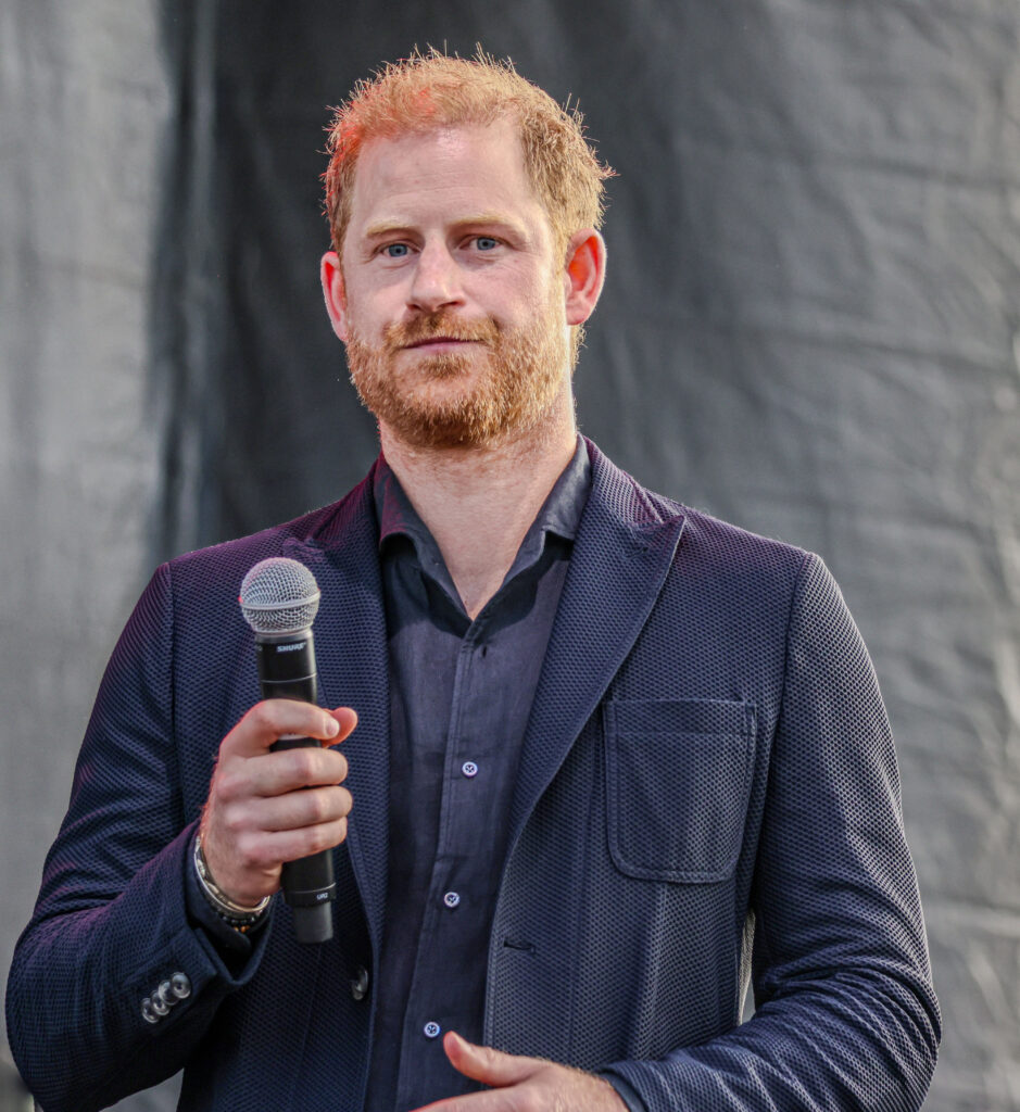 Prince Harry holding a microphone