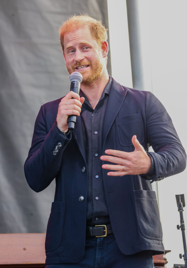 Prince Harry holding a microphone