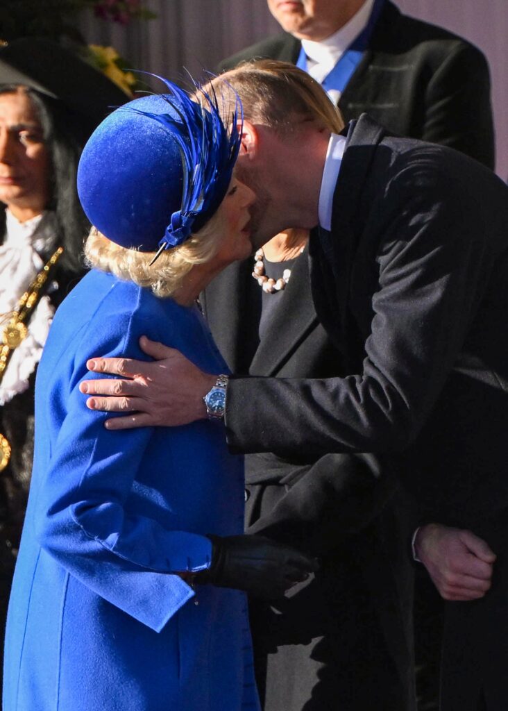 Queen Camilla kissing Prince William's cheek