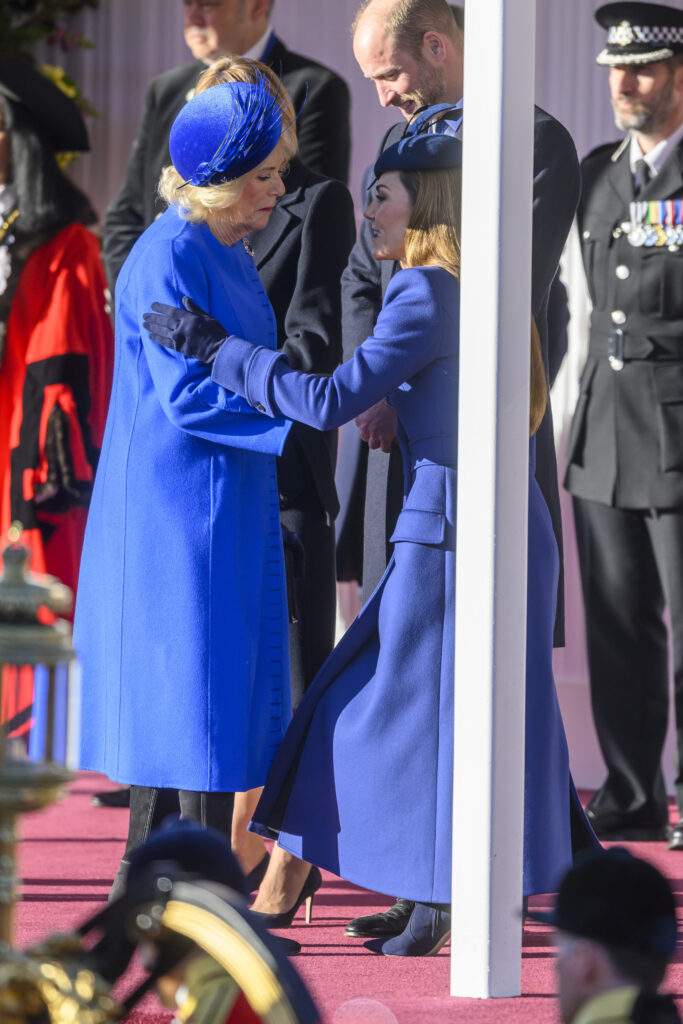 Kate Middleton curtsying to Queen Camilla