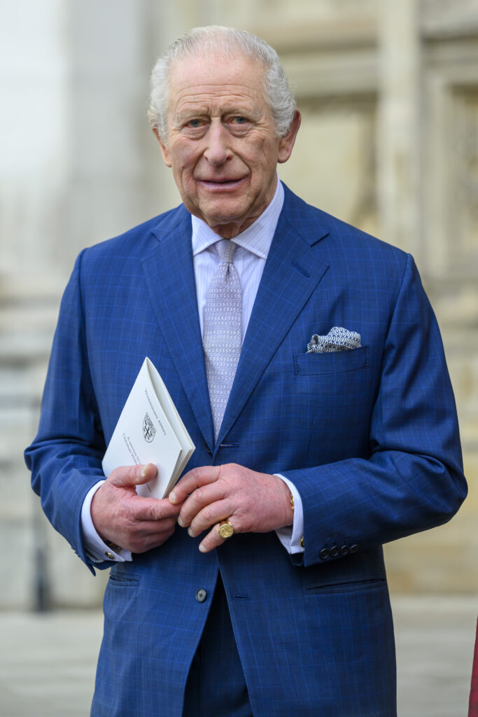 King Charles walking in blue suit