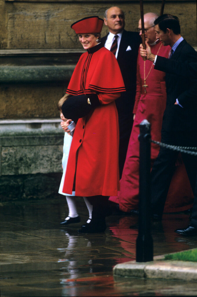 Princess Diana wearing a red cape coat on Christmas Day 1986