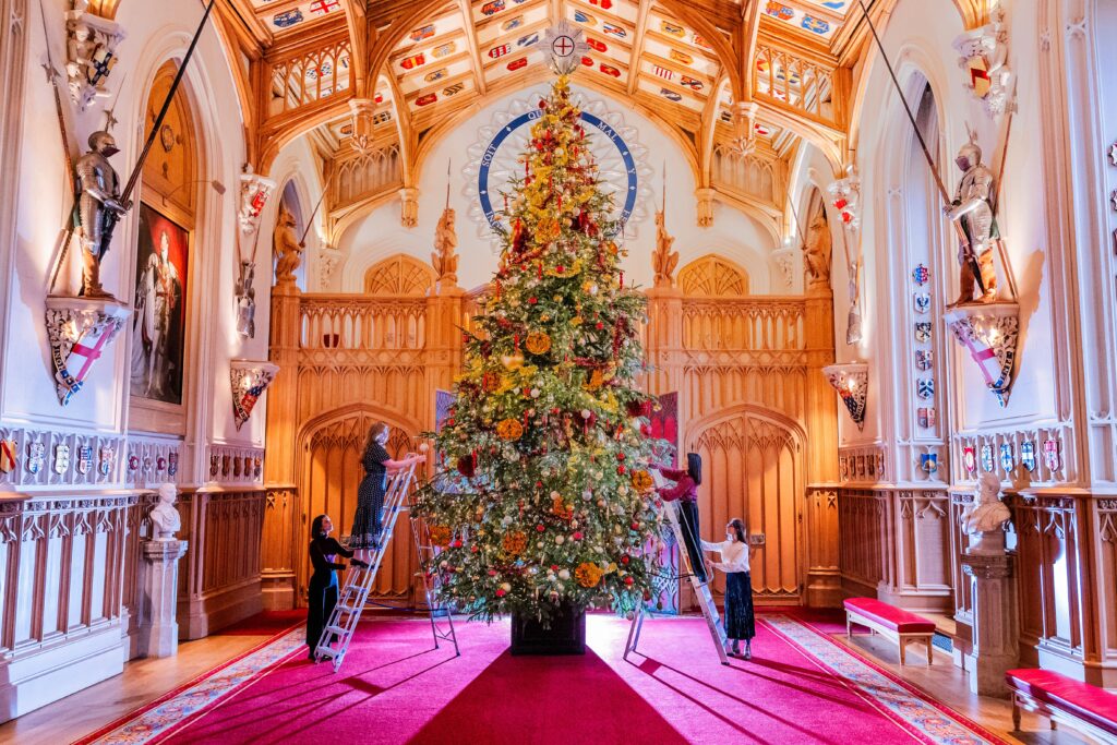Final adjustments to A 20-foot-high Nordmann Fir tree in St George's Hall, grown nearby in Windsor Great Park and illuminated with thousands of lights - Christmas decorations in the State Apartments at Windsor Castle.Christmas decorations at Windsor Castle., Windsor Castle, Windsor, UK - 21 Nov 2024