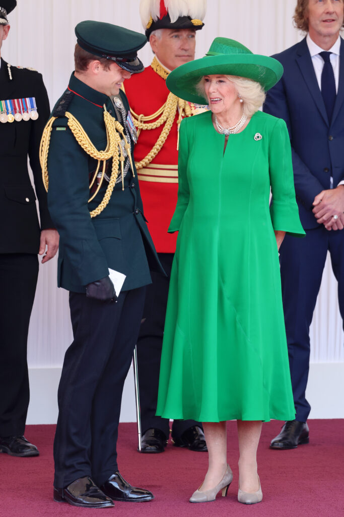 Queen Camilla laughing with equerry Ollie Plunket
