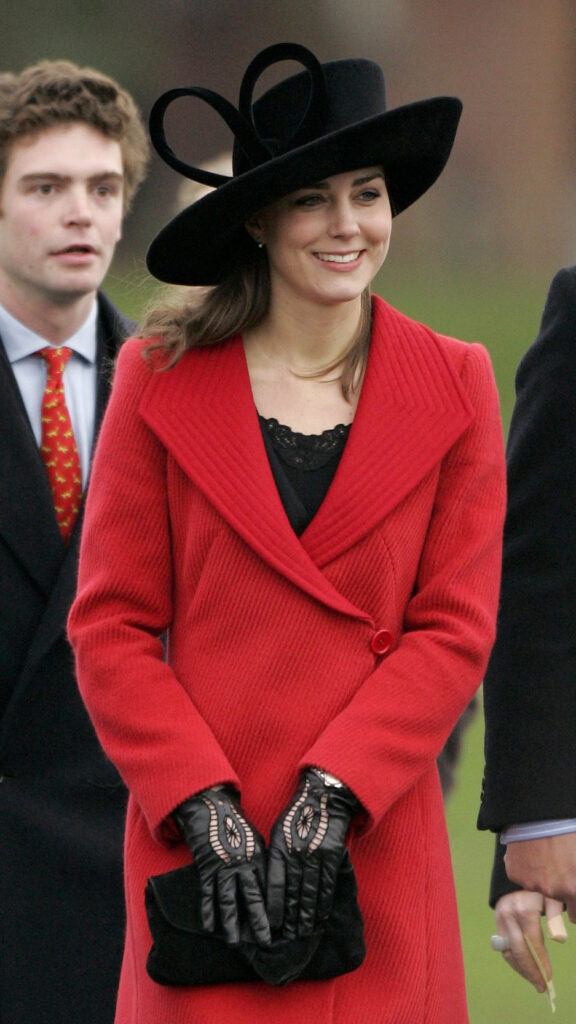 Kate Middleton wearing a red coat and black hat, at Sandhurt, 2006.