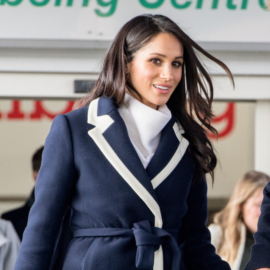 Meghan Markle smiling and walking