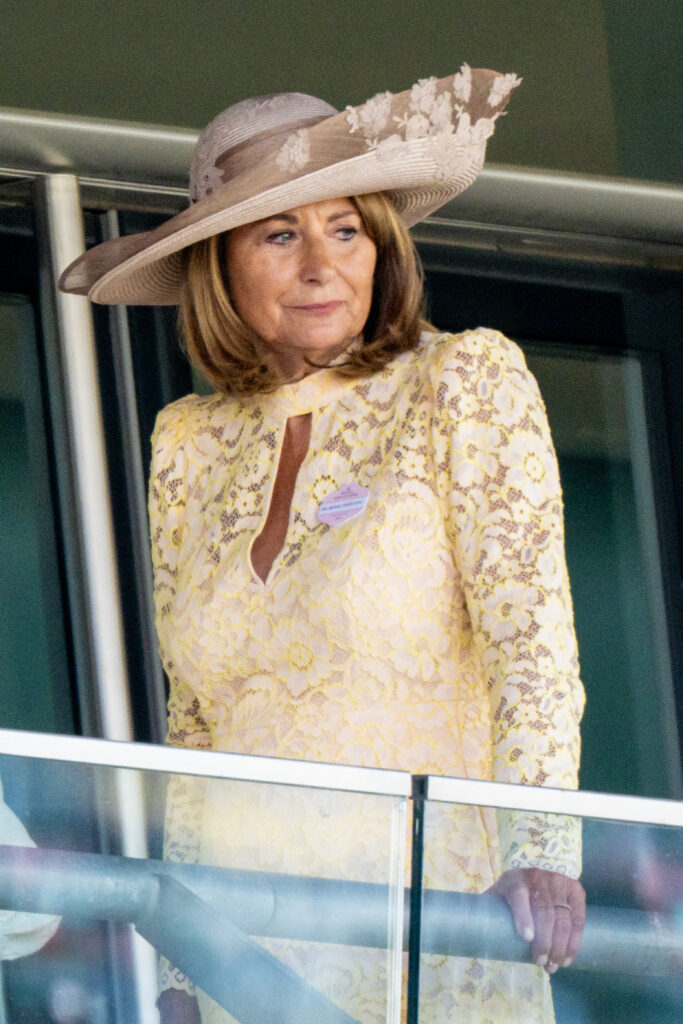 Carole Middleton wearing a yellow dress and a hat