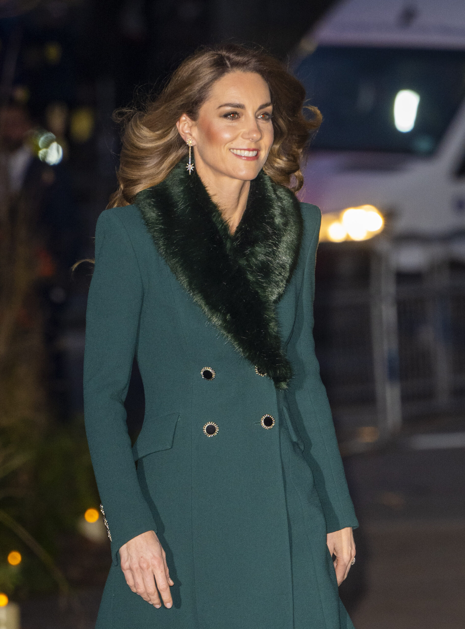 Princess Kate smiling wearing a green coat dress