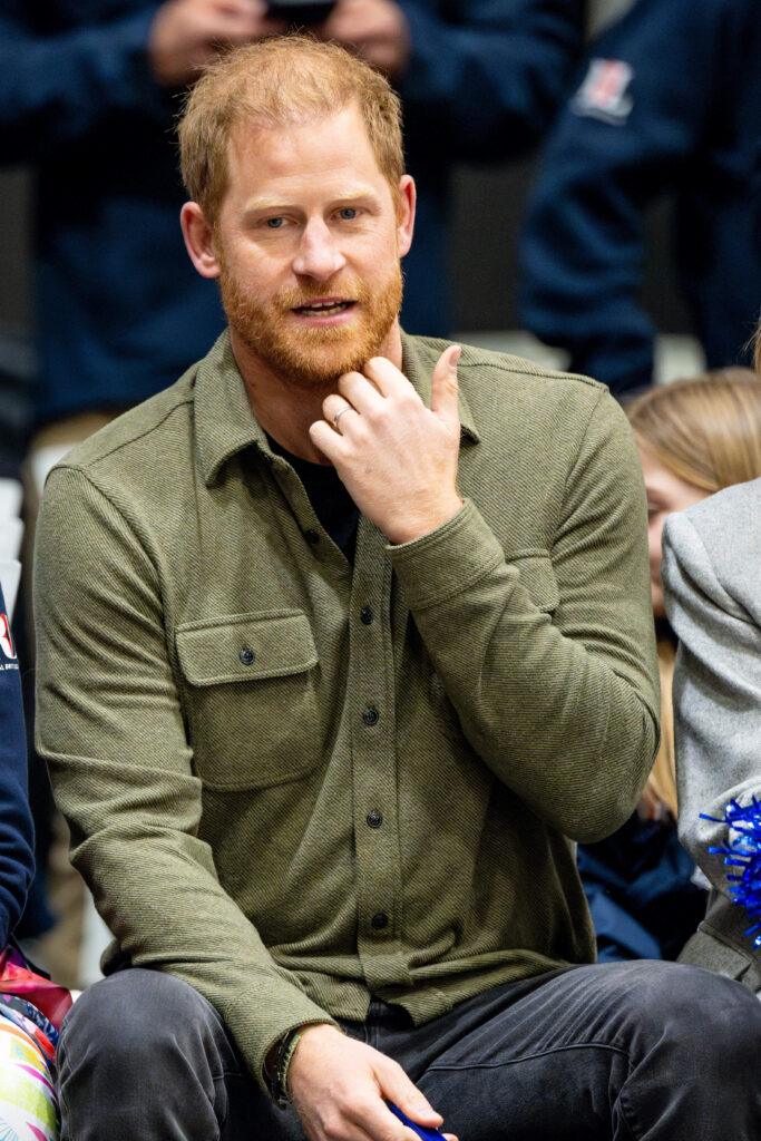 Prince Harry speaking and scratching his chin
