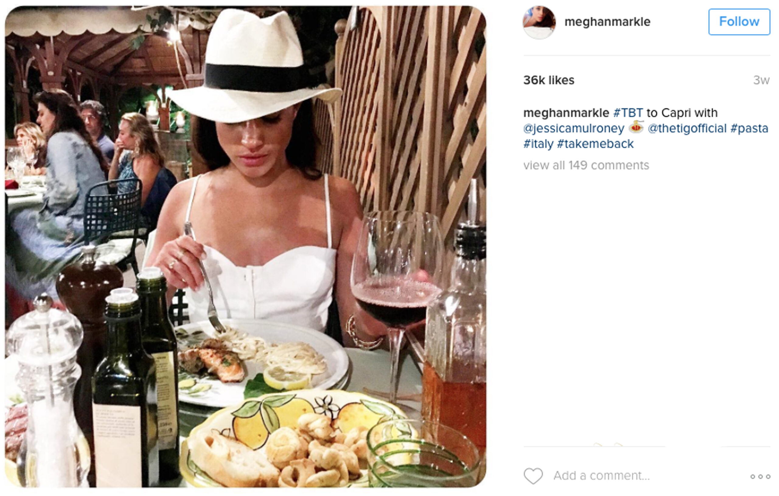 Meghan Markle looking down and eating wearing a white hat in a post to Instagram