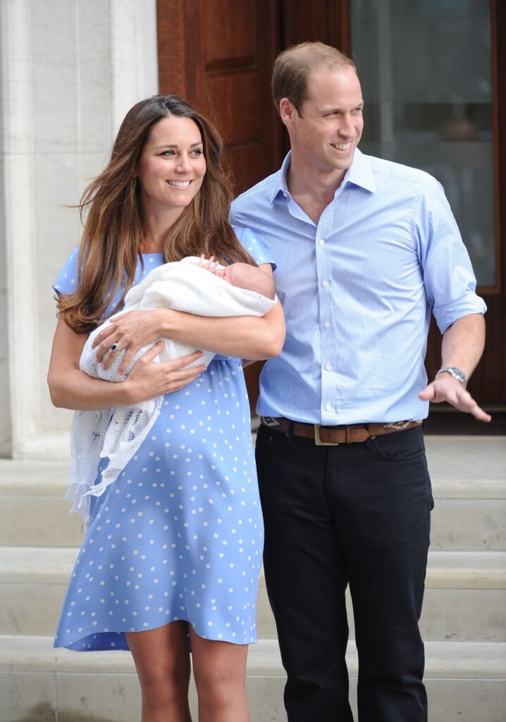 Kate Middleton and Prince William holding George after his birth
