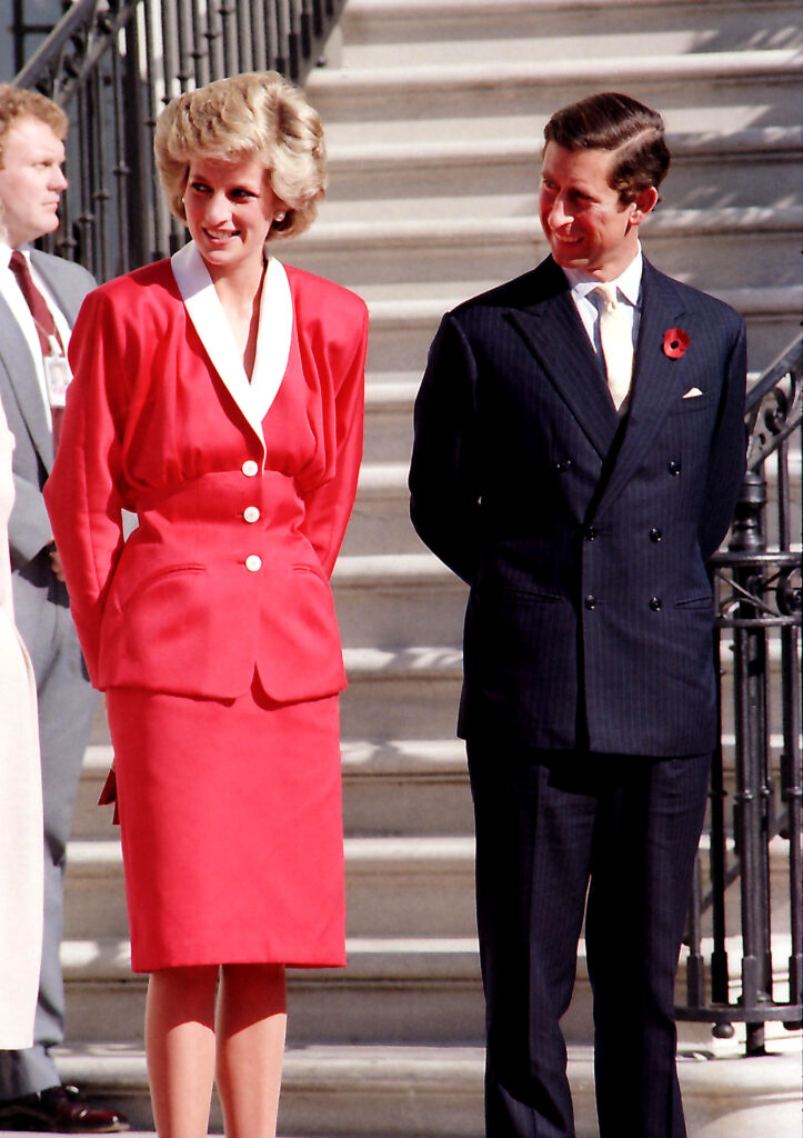 Princess Diana and Prince Charles stood side by side, looking away from each other