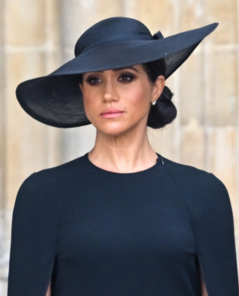 Meghan Markle wearing a black hat and dress at the State Funeral of Queen Elizabeth I