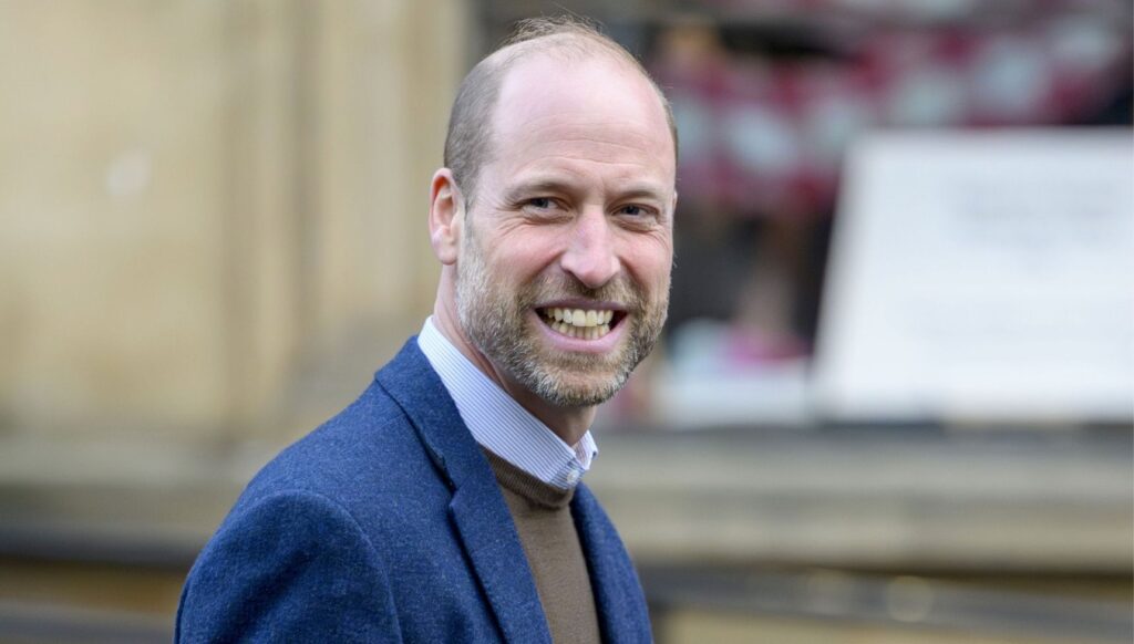 Prince William smiling in blue blazer in Scotland