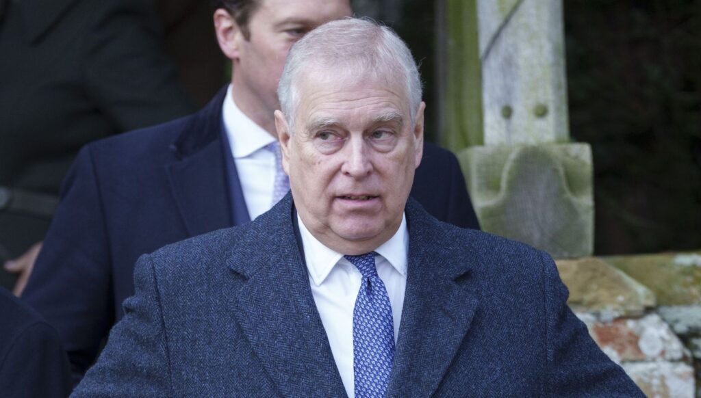 Andrew Mountbatten Windsor in a suit looking fed up