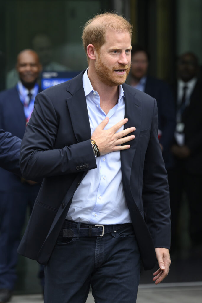 Prince Harry with his hand on his chest on UK visit