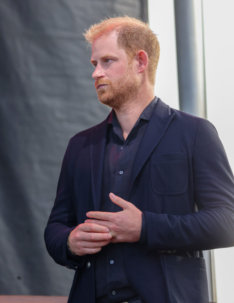 Prince Harry wears a black suit