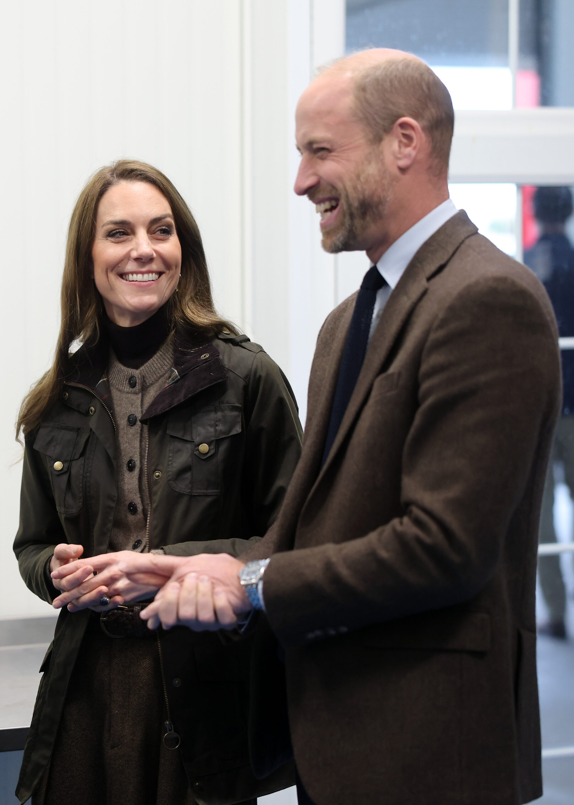 Prince William and Kate Middleton smiling during royal visit