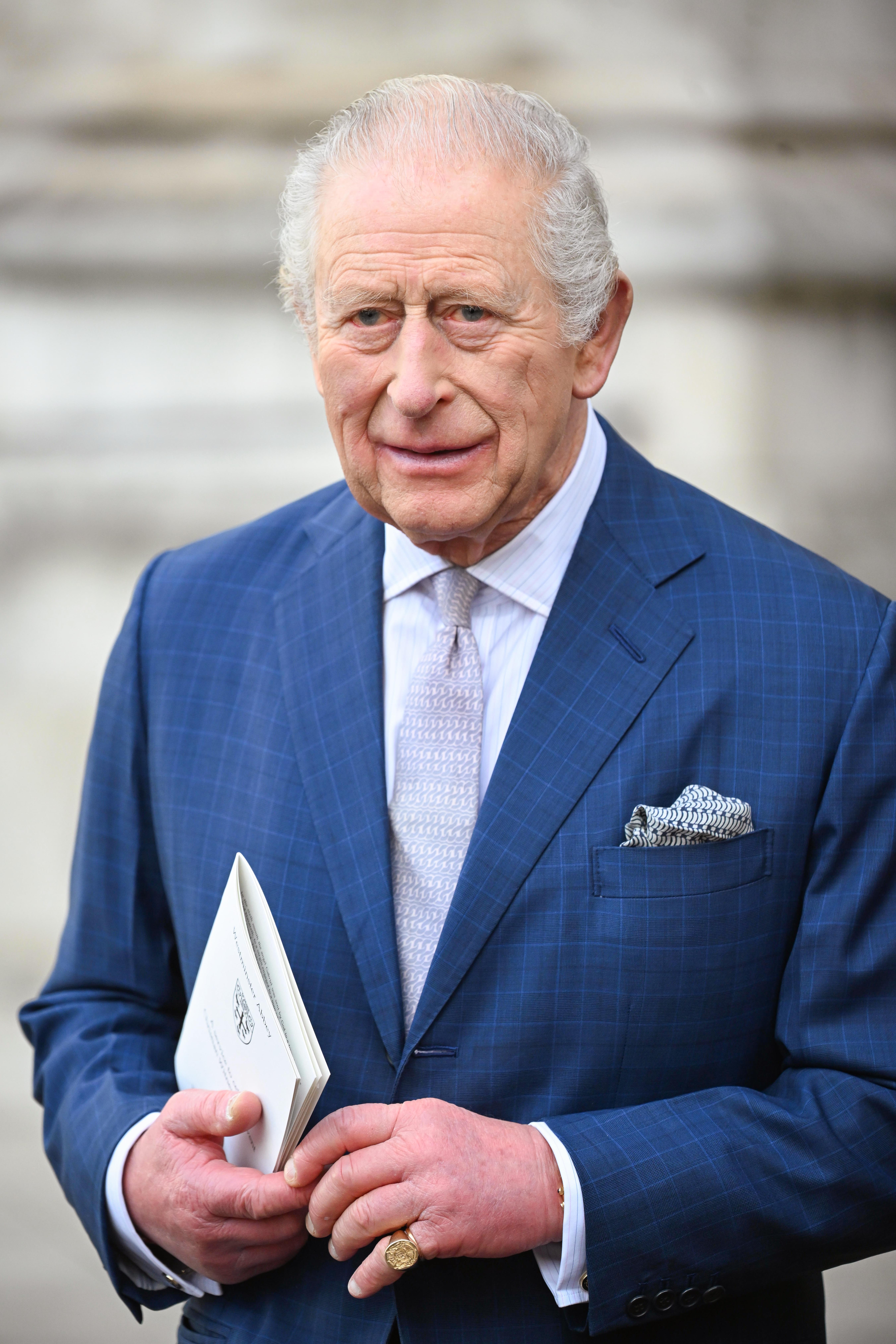 King Charles walking in blue suit