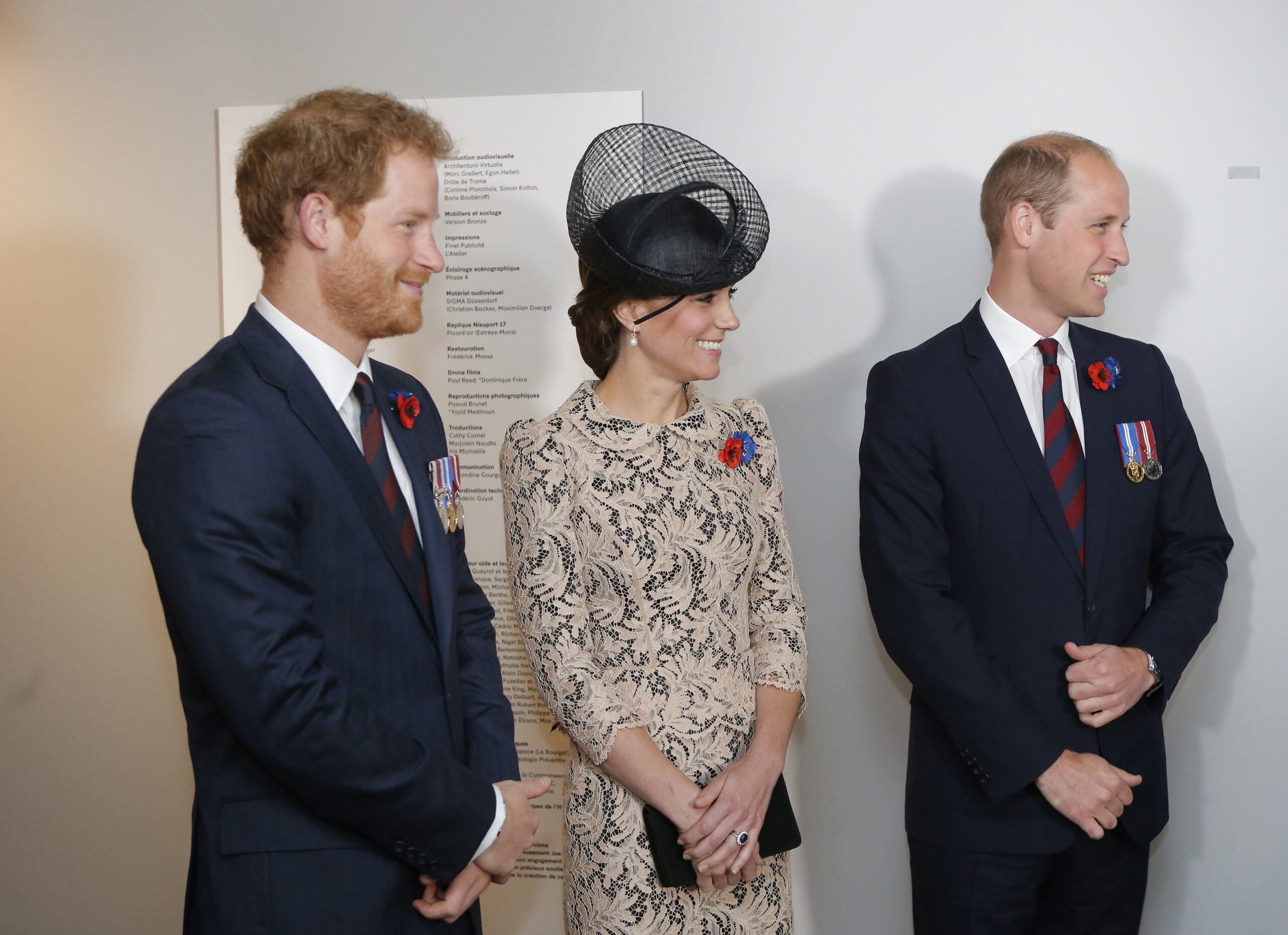 Prince Harry smiling beside Princess Kate and Prince William